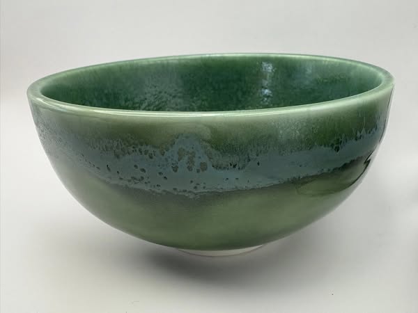 Green ceramic bowl on a white background