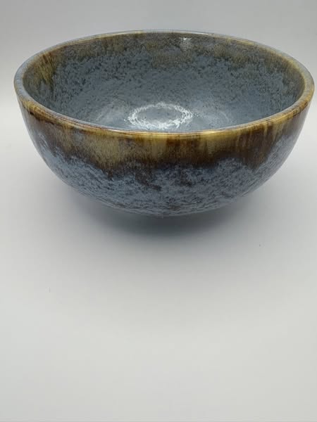 Ceramic bowl with a textured surface on a plain background