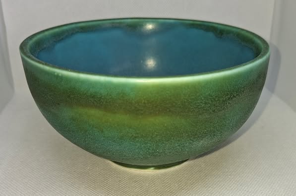Green ceramic bowl on a light gray background