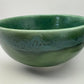 Green ceramic bowl on a white background