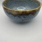 Ceramic bowl with a textured surface on a plain background