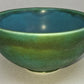 Green ceramic bowl on a light gray background