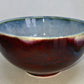 Ceramic bowl with a gradient from blue to red on a white background