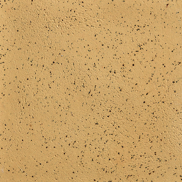 A close-up image of a speckled stoneware clay surface in a buff color.